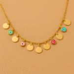 Gold necklace with colorful enamel charms and polished round discs on golden background by H&A Jeweller