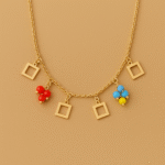 Gold necklace with open square charms and colorful bead clusters on a matte background by H&A Jeweller