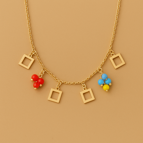 Gold necklace with open square charms and colorful bead clusters on a matte background by H&A Jeweller