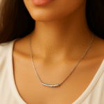Model wearing a sleek silver bar pendant necklace on a delicate chain by H&A Jeweller
