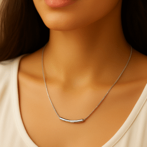 Model wearing a sleek silver bar pendant necklace on a delicate chain by H&A Jeweller