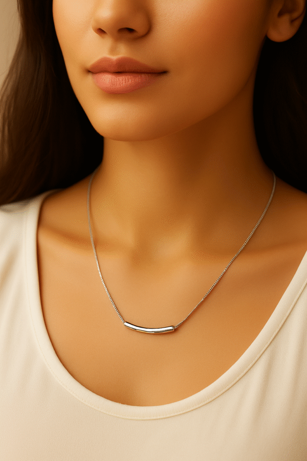 Model wearing a sleek silver bar pendant necklace on a delicate chain by H&A Jeweller