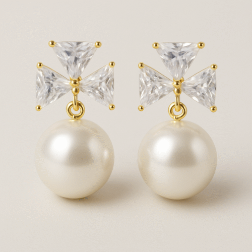 H&A gold-tone earrings with crystal bow design and round pearl drops